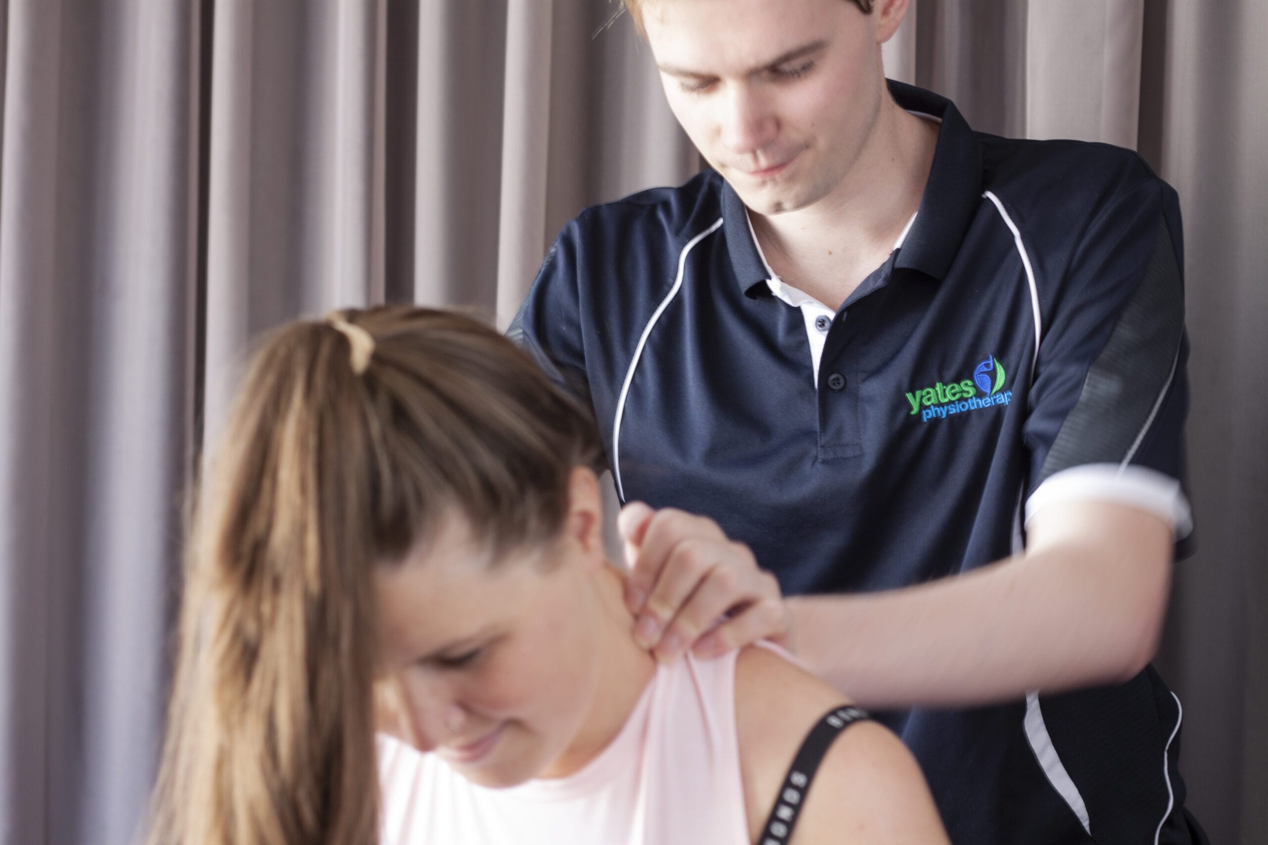 A woman receiving a therapeutic shoulder massage from a physiotherapist to alleviate pain and promote relaxation.