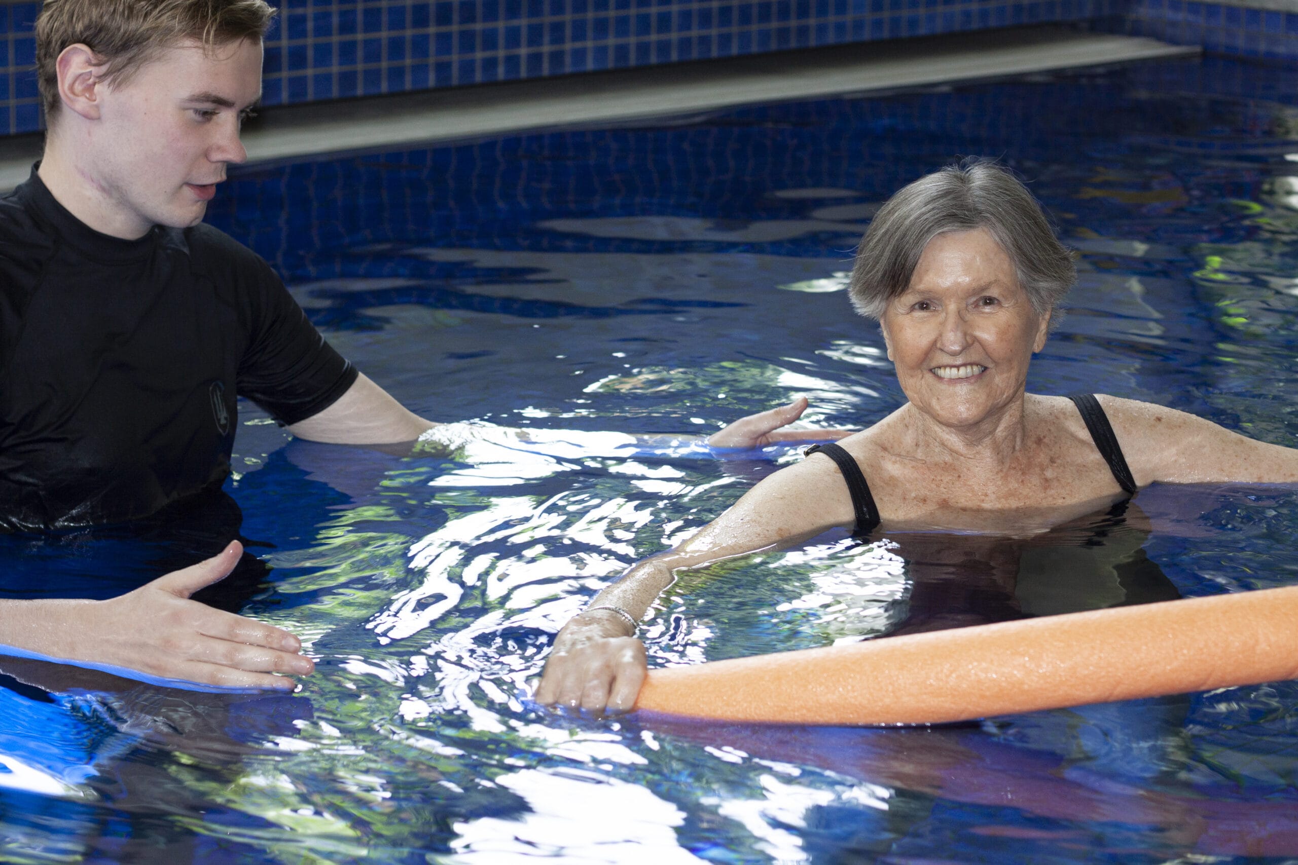 A person undergoing hydrotherapy exercises in a pool with the assistance of a physiotherapist at Yates Physiotherapy, Adelaide